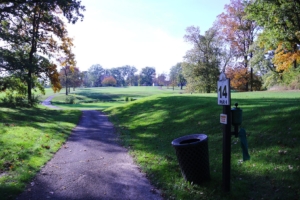 Trail winding through the green fields and slopes of the Donald Ross Golf Course on a beautiful day