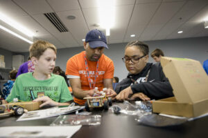 Professor helping assemble a remote car