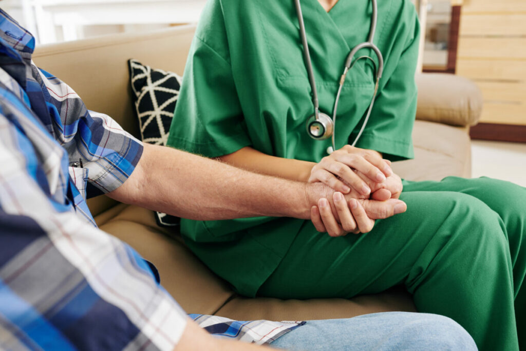 Nurse supporting senior patient