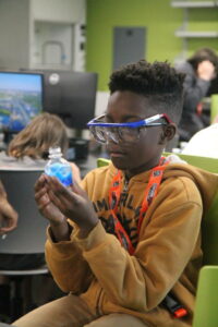 student holding a blue flask