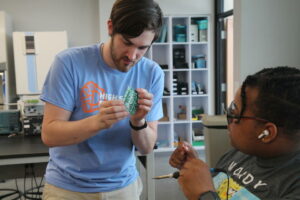 Instructor inspecting a circuit board